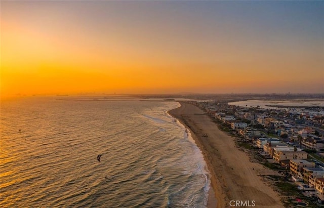 drone / aerial view featuring a water view and a beach view