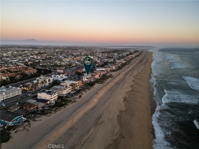 birds eye view of property featuring a view of the beach and a water view