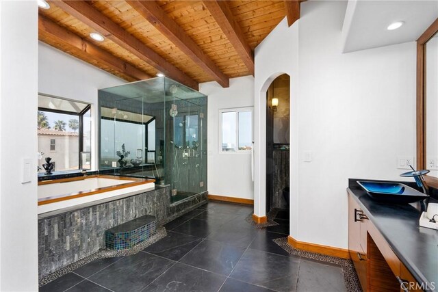 bathroom featuring a stall shower, wood ceiling, vanity, beamed ceiling, and a bath