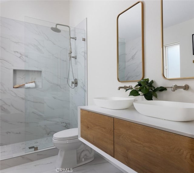 full bathroom with toilet, marble finish floor, a marble finish shower, and a sink