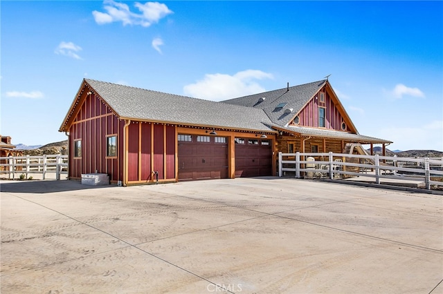 33210 Crown Valley Rd, Temecula, CA 92592 - view of side of property with fence, an attached garage, driveway, board and batten siding, and a shingled roof