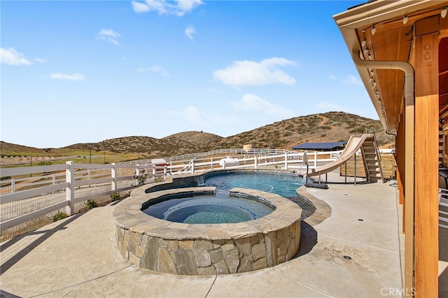 33210 Crown Valley Rd, Temecula, CA 92592 - view of swimming pool with a mountain view, a water slide, fence, a pool with connected hot tub, and a patio area
