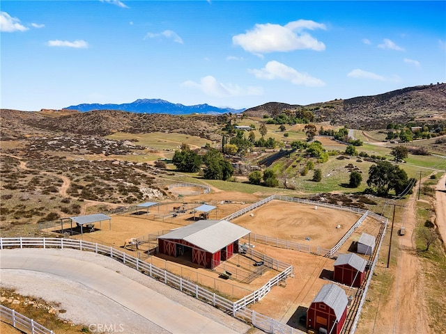 birds eye view of property featuring a mountain view and a rural view