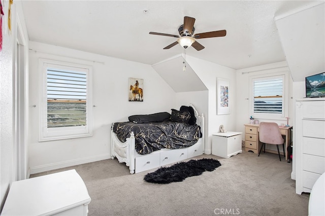 bedroom featuring carpet floors, ceiling fan, baseboards, and lofted ceiling