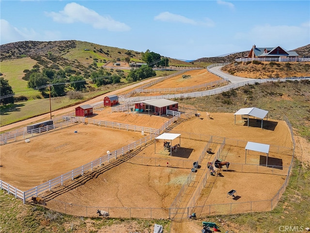 birds eye view of property with a mountain view and a rural view