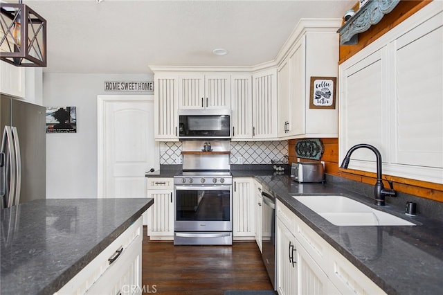 33210 Crown Valley Rd, Temecula, CA 92592 - kitchen featuring appliances with stainless steel finishes, a sink, dark wood-style flooring, tasteful backsplash, and white cabinets