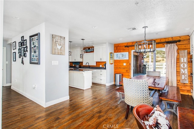 33210 Crown Valley Rd, Temecula, CA 92592 - dining room with a chandelier, dark wood finished floors, baseboards, and a textured ceiling