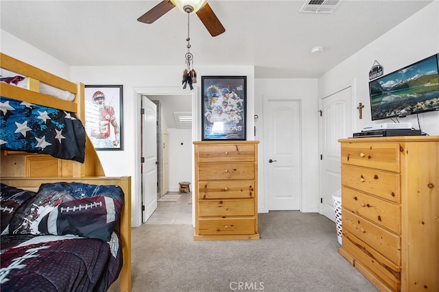 bedroom with carpet, visible vents, and a ceiling fan