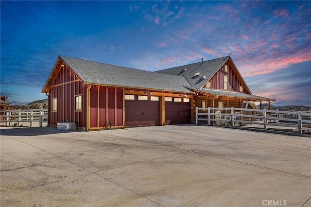 33210 Crown Valley Rd, Temecula, CA 92592 - property exterior at dusk featuring fence, a garage, concrete driveway, and board and batten siding