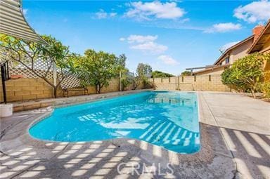 view of swimming pool with a patio, a fenced backyard, and a fenced in pool