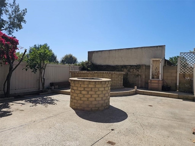 view of patio featuring a fire pit and a fenced backyard