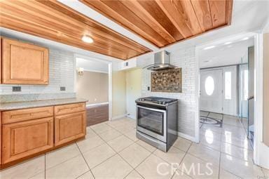 kitchen featuring wood ceiling, exhaust hood, light tile patterned floors, and stove