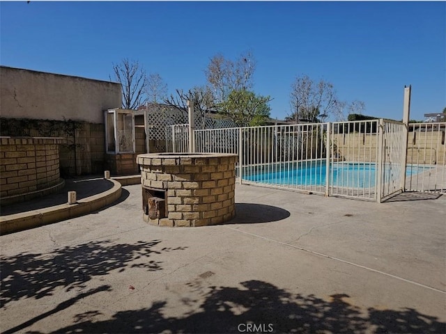 view of swimming pool with a fenced in pool, fence, and a patio