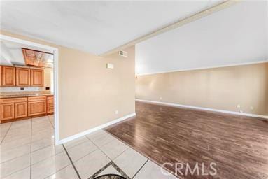 empty room with light wood-style flooring and baseboards