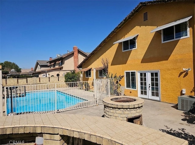 view of swimming pool featuring a fenced in pool, french doors, a patio, and fence