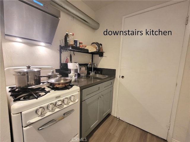 11865 Exline St Unit B, El Monte, CA 91732 - kitchen with open shelves, white gas range, a sink, dark countertops, and light wood-style floors