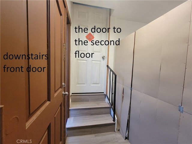 staircase with wood finished floors