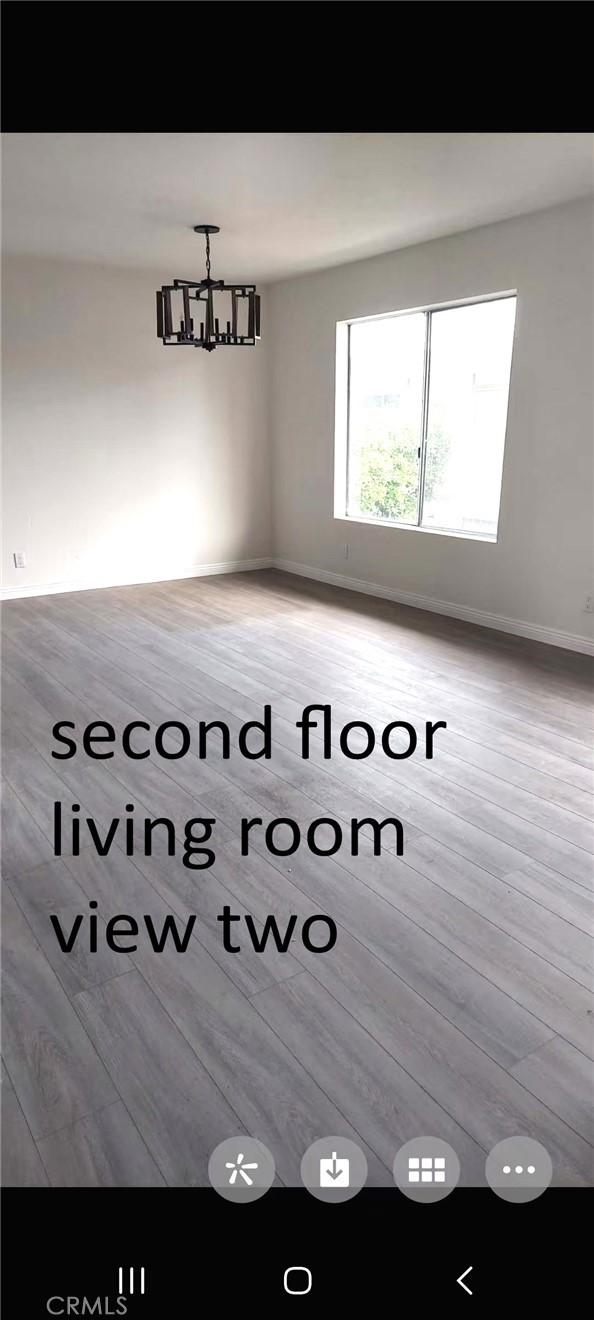 unfurnished dining area with light wood-style floors, a chandelier, and baseboards