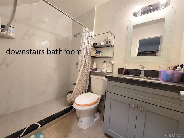 full bath with a textured wall, a stall shower, vanity, and toilet