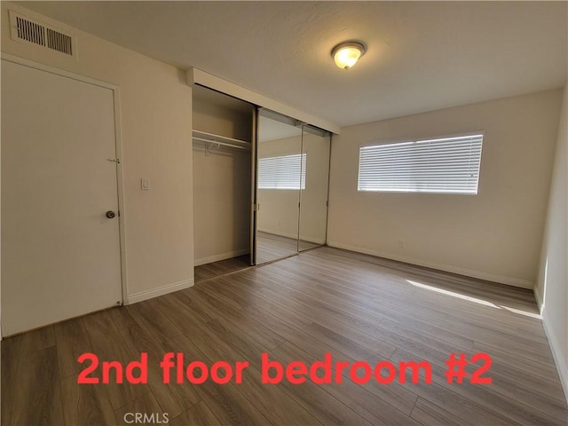 11865 Exline St Unit B, El Monte, CA 91732 - unfurnished bedroom with baseboards, visible vents, a closet, and wood finished floors