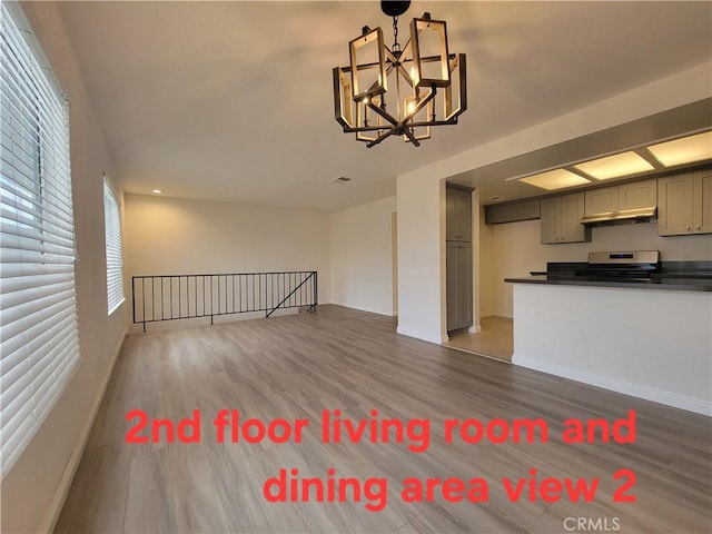 11865 Exline St Unit B, El Monte, CA 91732 - unfurnished living room with baseboards, a notable chandelier, and wood finished floors