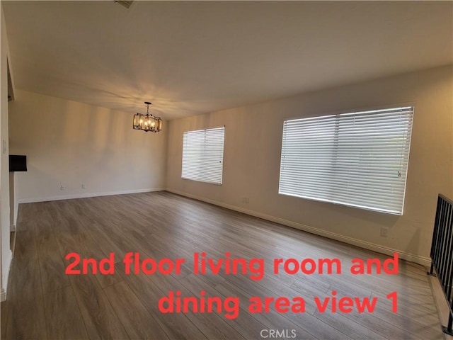 11865 Exline St Unit B, El Monte, CA 91732 - spare room featuring baseboards, wood finished floors, and a chandelier