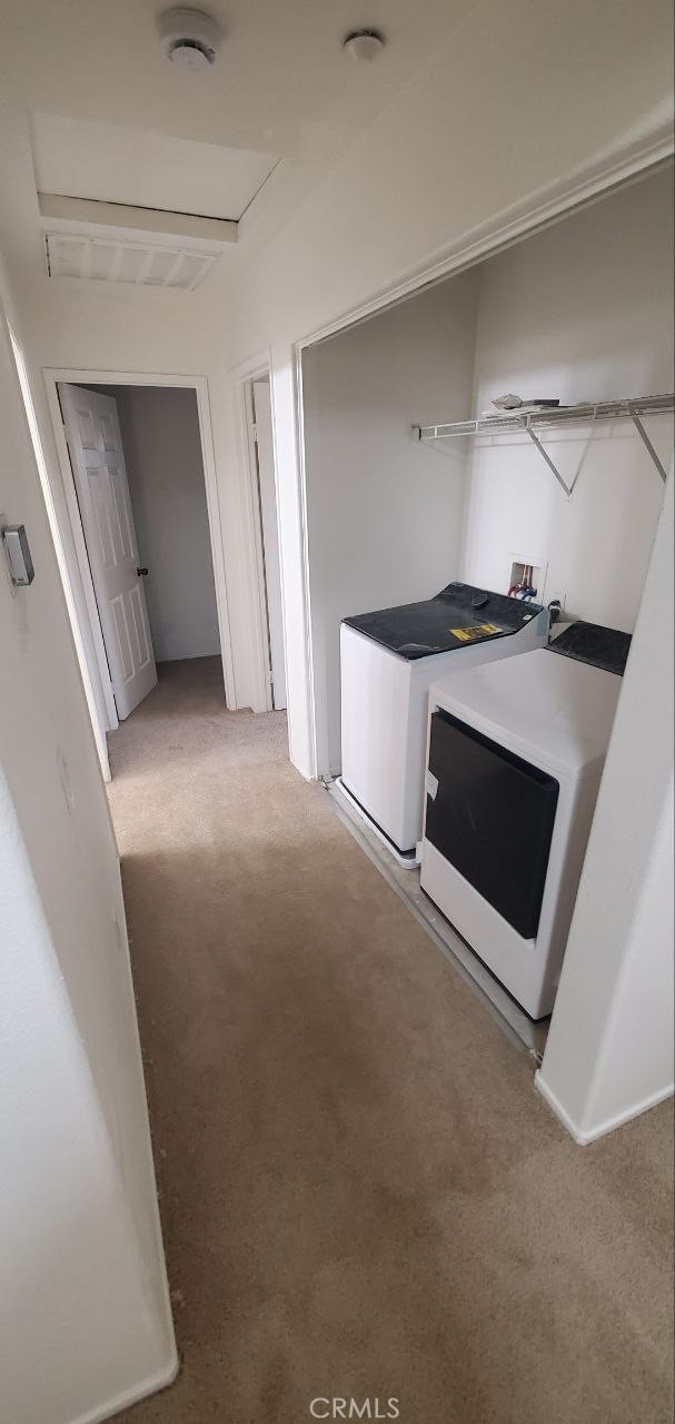 interior space with carpet flooring and washing machine and clothes dryer