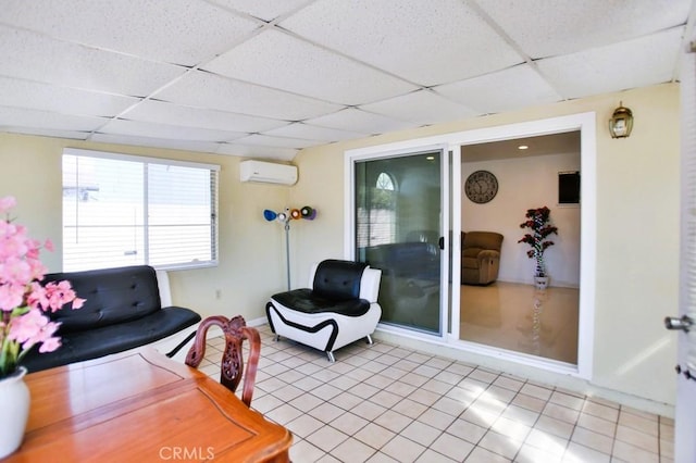 interior space featuring a drop ceiling and a wall unit AC