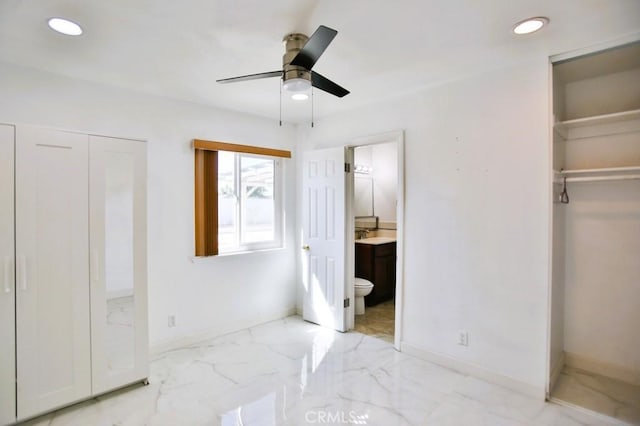 bedroom with marble finish floor, baseboards, ensuite bathroom, and recessed lighting