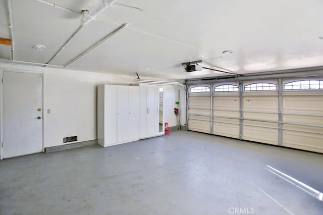 garage featuring baseboards and a garage door opener