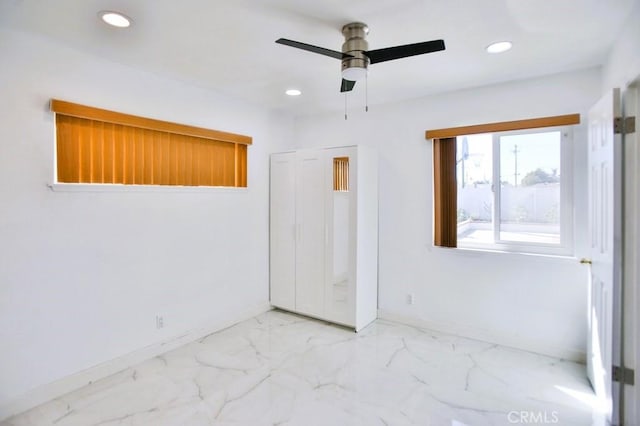 unfurnished bedroom featuring baseboards, marble finish floor, a ceiling fan, and recessed lighting