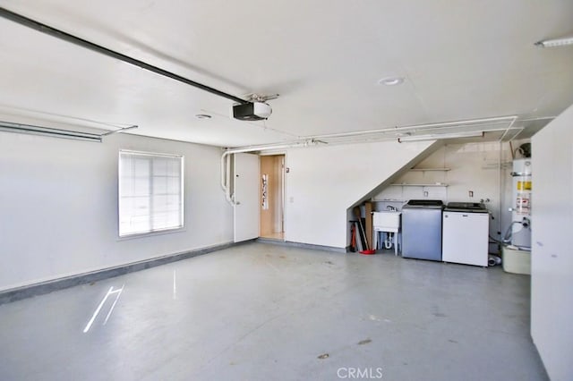 parking deck with a garage door opener, water heater, a sink, and washer and clothes dryer