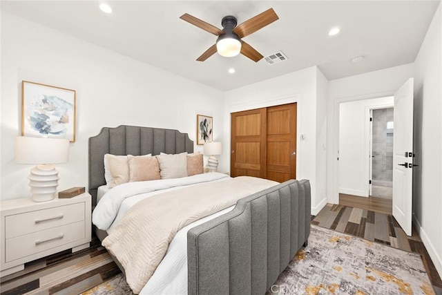 bedroom with recessed lighting, visible vents, baseboards, and a closet