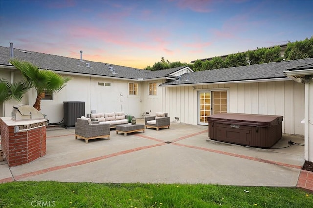 rear view of property with a patio, cooling unit, roof with shingles, outdoor lounge area, and a hot tub