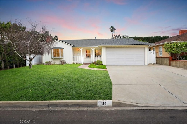 ranch-style house featuring fence, driveway, a porch, a garage, and a lawn