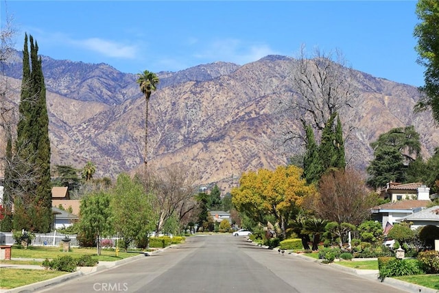 view of street with curbs and a mountain view