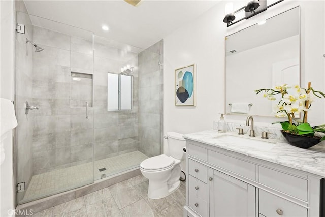 full bathroom featuring vanity, toilet, and a shower stall