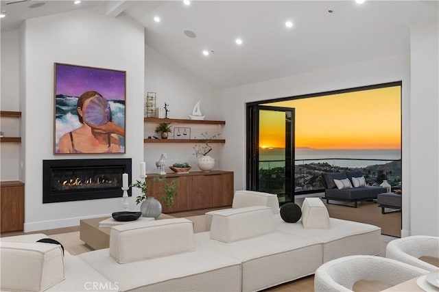 living room with a glass covered fireplace, beamed ceiling, a water view, high vaulted ceiling, and recessed lighting