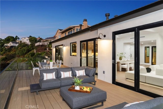 wooden deck with outdoor dining space and an outdoor hangout area