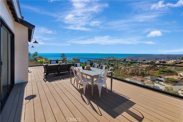 wooden terrace featuring a water view