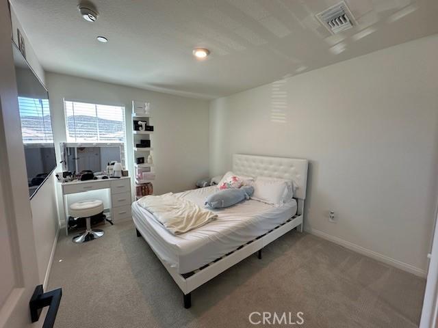 bedroom with visible vents, baseboards, and carpet floors