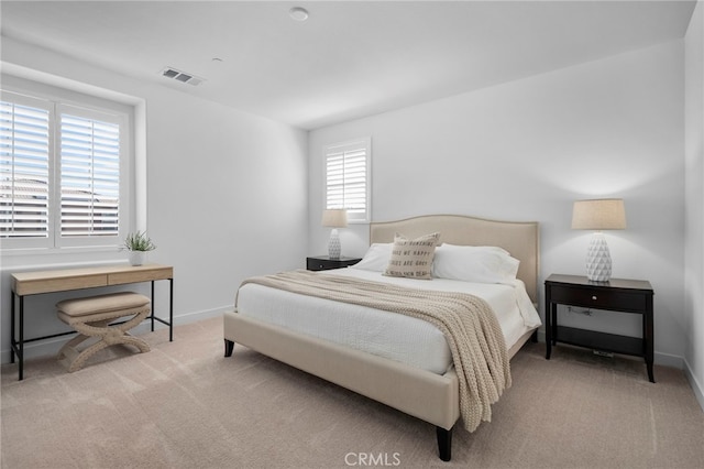 bedroom with carpet floors, baseboards, and visible vents