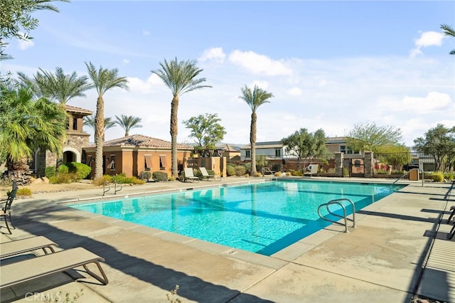 pool featuring a patio area and fence