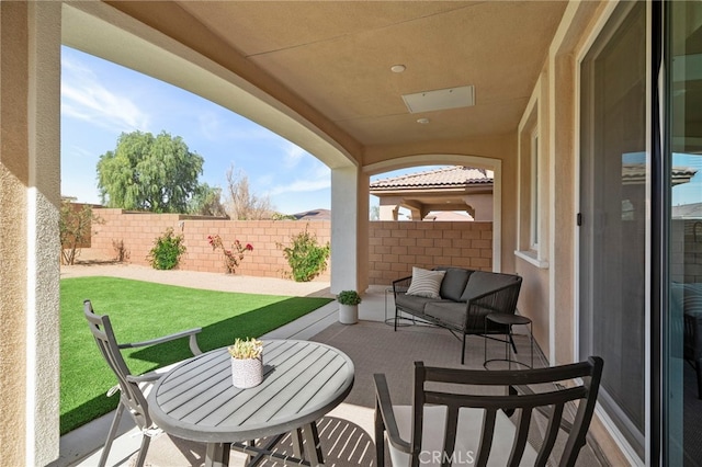 view of patio / terrace featuring fence and an outdoor living space