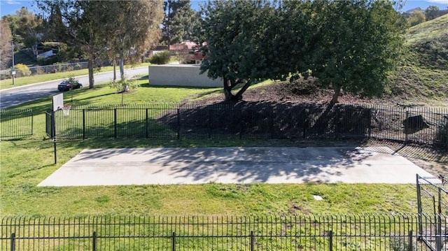 exterior space featuring basketball hoop and fence