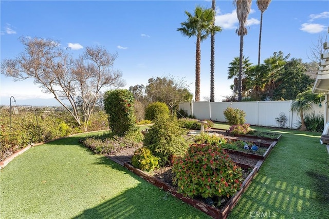 view of yard with a vegetable garden and fence