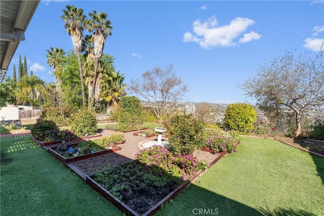 view of yard featuring fence and a garden