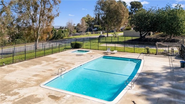 view of swimming pool featuring a fenced in pool, a yard, a patio area, fence, and an in ground hot tub