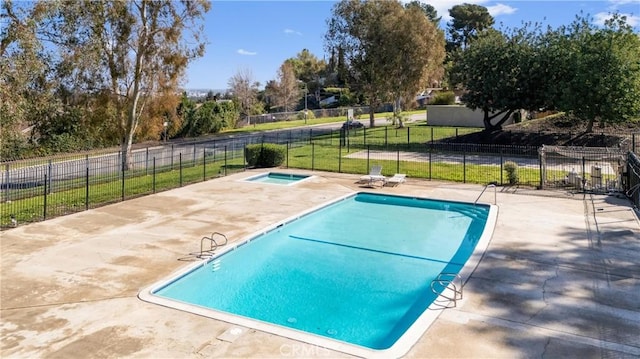 view of pool featuring a fenced in pool, a patio, an in ground hot tub, fence, and a yard