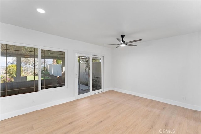 unfurnished room featuring light wood-type flooring and baseboards